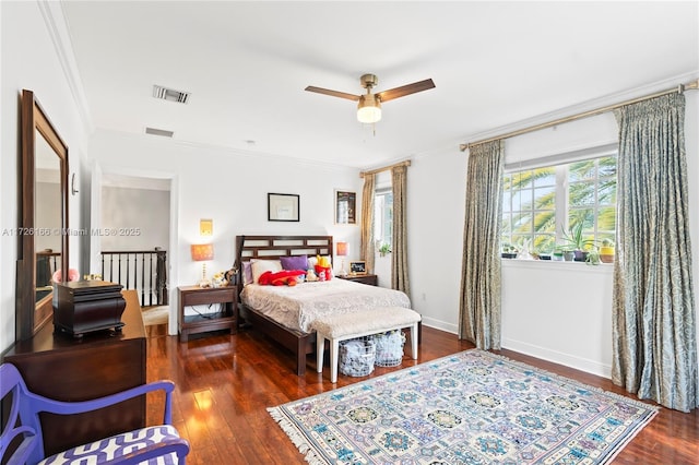 bedroom with ceiling fan, crown molding, and dark hardwood / wood-style floors