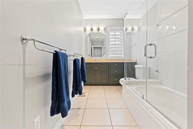 full bathroom featuring toilet, enclosed tub / shower combo, tile patterned floors, and vanity