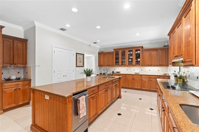 kitchen with light stone countertops, light tile patterned floors, decorative backsplash, a kitchen island with sink, and ornamental molding