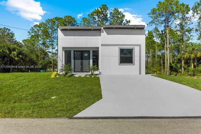 modern home featuring a front yard