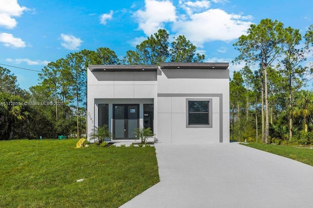 modern home featuring a front lawn