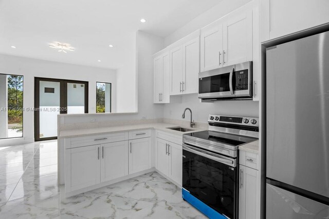 kitchen featuring white cabinetry, appliances with stainless steel finishes, sink, and french doors