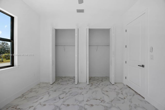 unfurnished bedroom featuring multiple closets