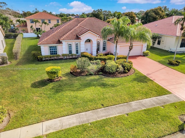 mediterranean / spanish home with a front lawn and a garage