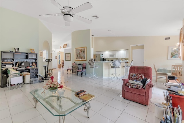 tiled living room featuring lofted ceiling and ceiling fan