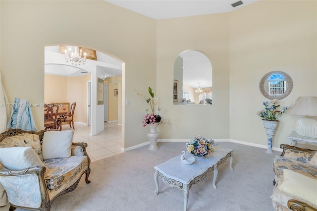 living room with an inviting chandelier and light tile patterned floors