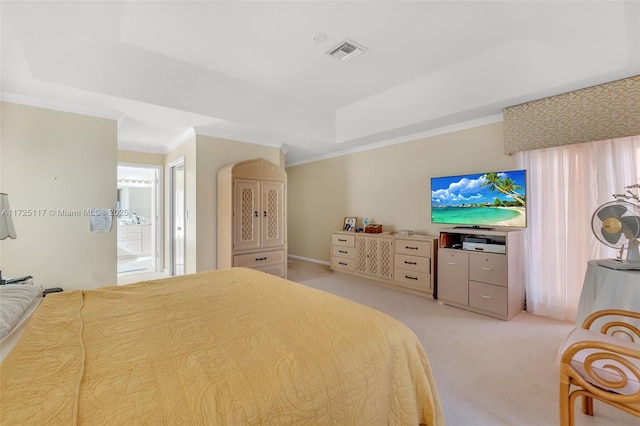 carpeted bedroom featuring ensuite bathroom, a raised ceiling, and ornamental molding