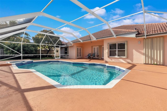 view of swimming pool featuring a lanai, a patio area, and french doors