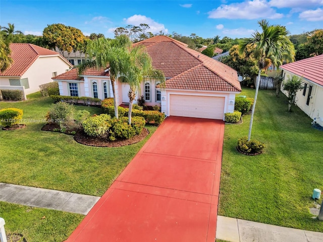 mediterranean / spanish home with a garage and a front yard