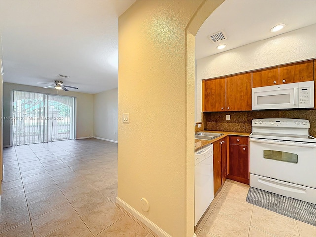 kitchen with white appliances, light tile patterned floors, ceiling fan, sink, and backsplash