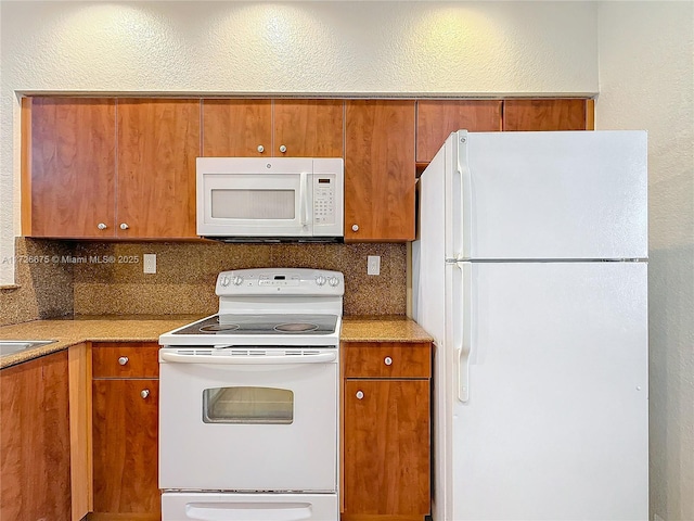 kitchen with white appliances and decorative backsplash