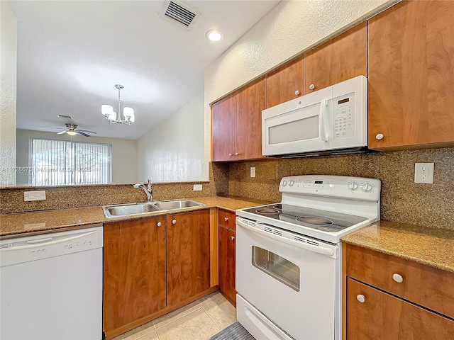 kitchen featuring white appliances, sink, tasteful backsplash, light tile patterned flooring, and ceiling fan with notable chandelier