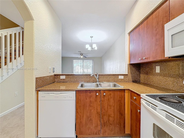 kitchen with sink, decorative light fixtures, white appliances, ceiling fan, and tasteful backsplash