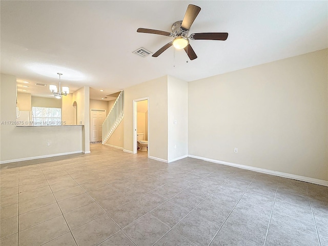 interior space with ceiling fan with notable chandelier and light tile patterned floors