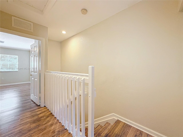 hallway with radiator and hardwood / wood-style flooring