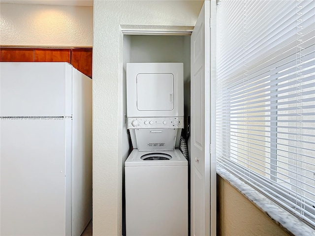 laundry room featuring stacked washer / dryer