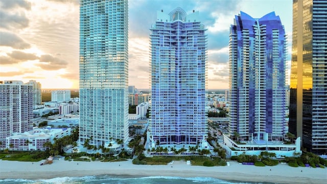 view of city with a beach view and a water view