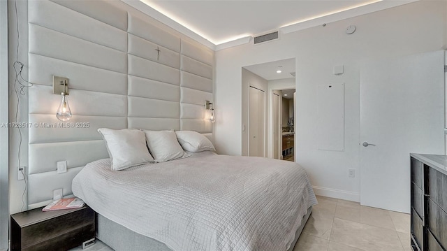 tiled bedroom featuring a closet