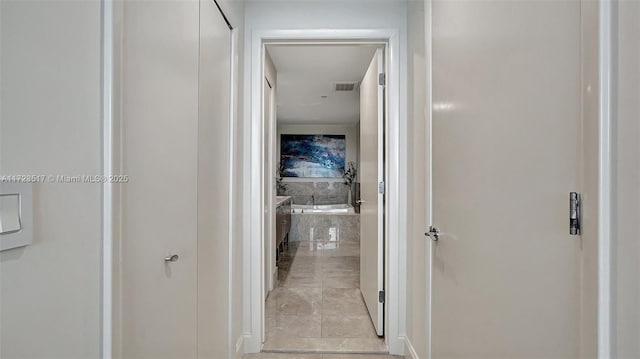 hallway featuring light tile patterned flooring