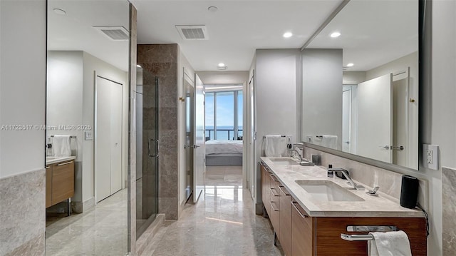 bathroom featuring a water view, an enclosed shower, and vanity