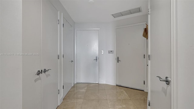 hall featuring light tile patterned floors