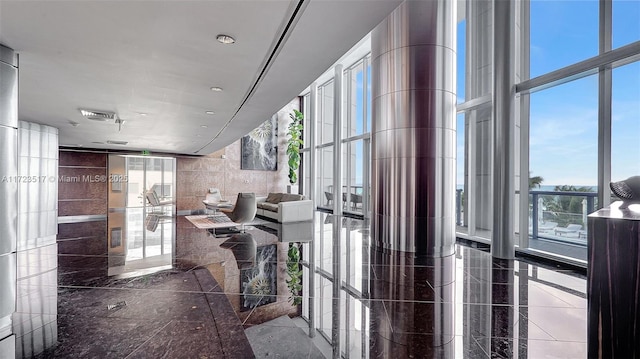 hallway with floor to ceiling windows