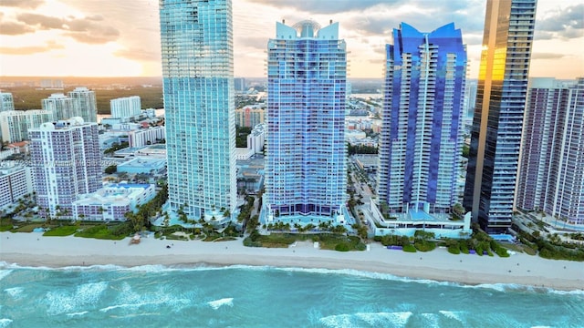 view of city with a beach view and a water view