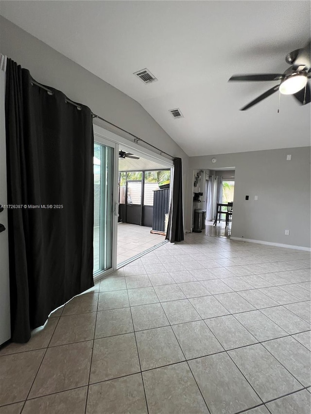 tiled empty room featuring lofted ceiling and ceiling fan