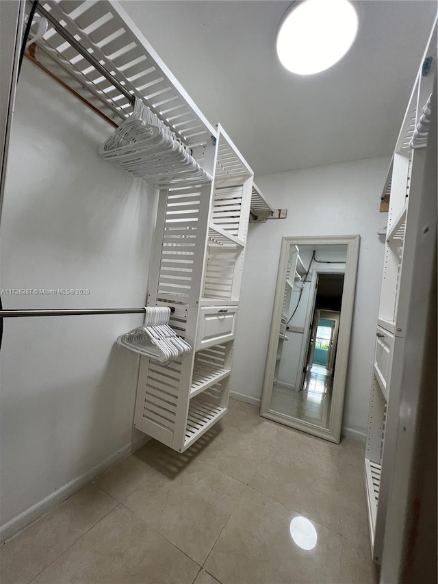 walk in closet featuring light tile patterned floors