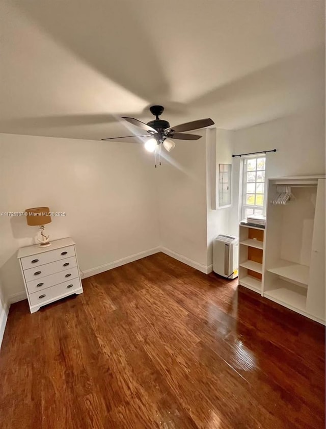 additional living space with ceiling fan and dark hardwood / wood-style flooring