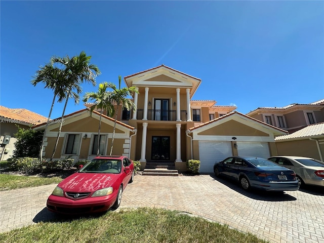 view of front facade featuring a balcony and a garage