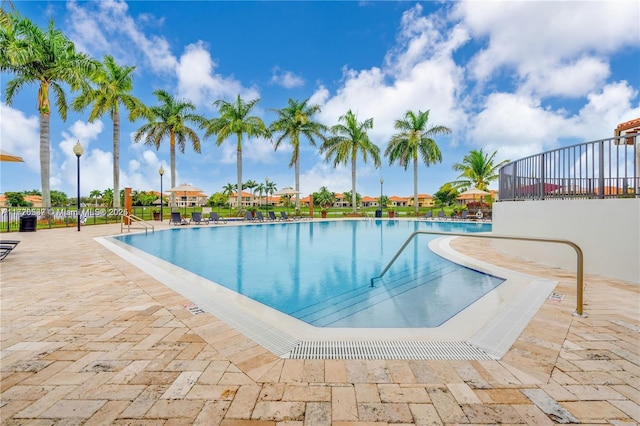 pool featuring a patio and fence