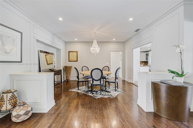 dining room featuring dark wood-type flooring and crown molding