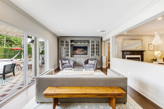 living room with crown molding and hardwood / wood-style floors