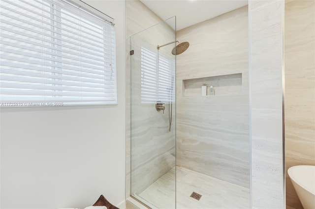 bathroom featuring shower with separate bathtub