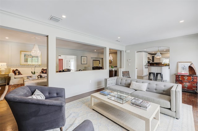 living room with crown molding and hardwood / wood-style floors