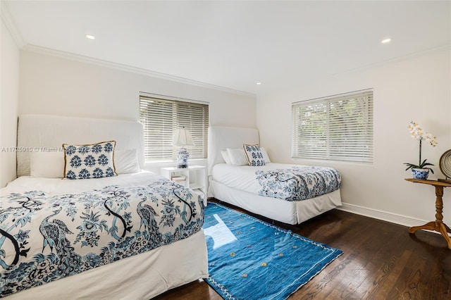 bedroom with dark hardwood / wood-style floors and crown molding