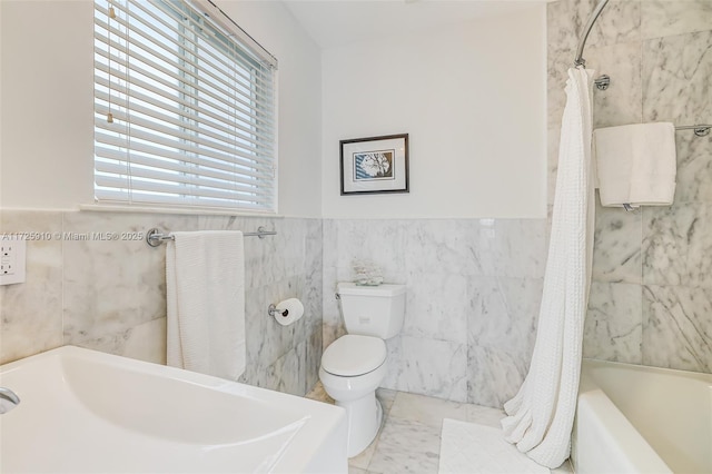 bathroom with tile walls, toilet, and shower / bathtub combination with curtain