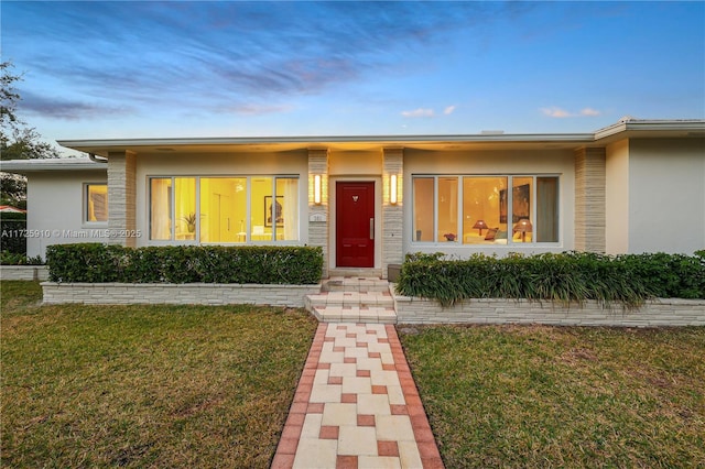 view of front of house with a yard