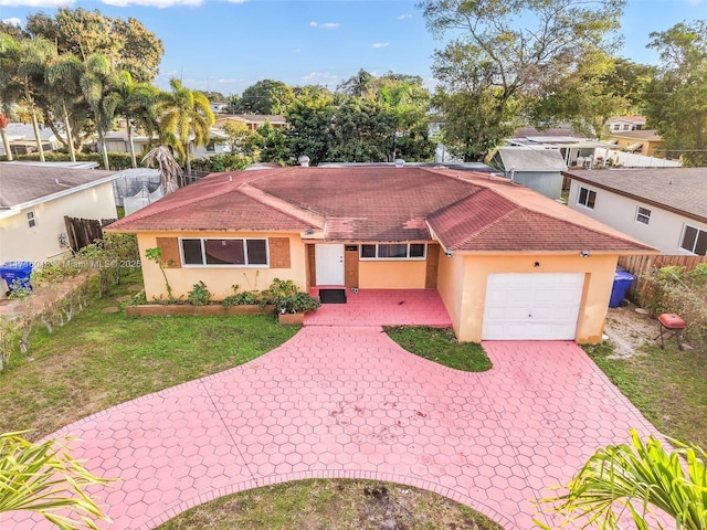 view of front of property with a front yard and a garage