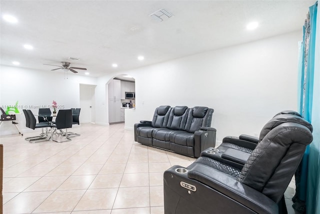 living room featuring ceiling fan and light tile patterned floors