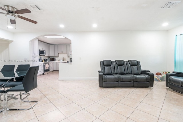 tiled living room with ceiling fan