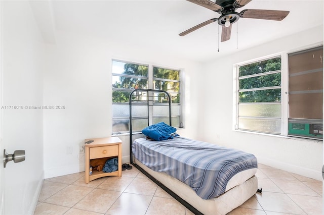 tiled bedroom featuring ceiling fan