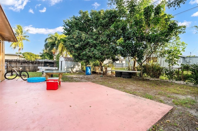 view of patio with a storage shed