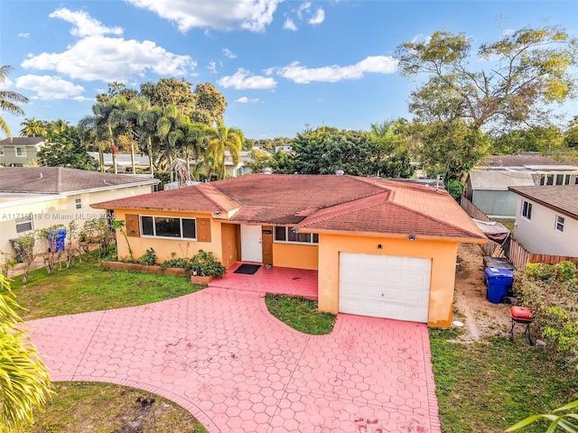 view of front of home featuring a garage and a front lawn