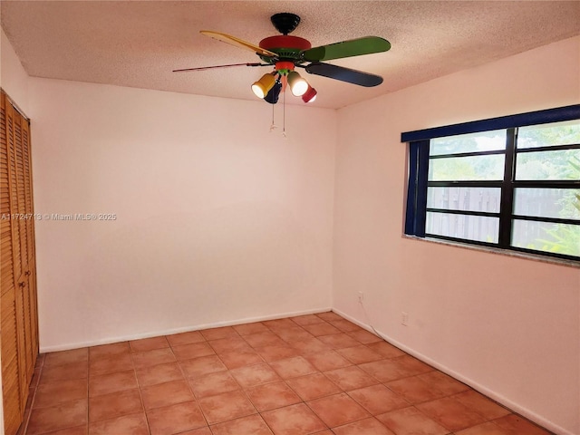 spare room featuring a textured ceiling and ceiling fan