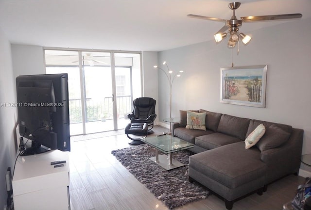 living room with floor to ceiling windows, ceiling fan, a wealth of natural light, and hardwood / wood-style floors