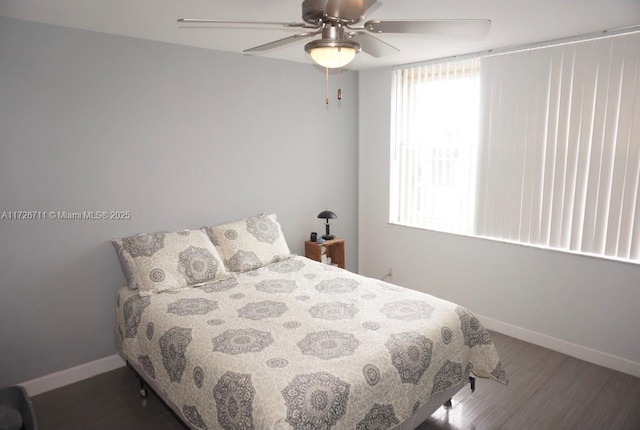 bedroom with ceiling fan and dark hardwood / wood-style flooring