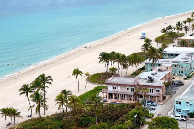 birds eye view of property with a beach view and a water view