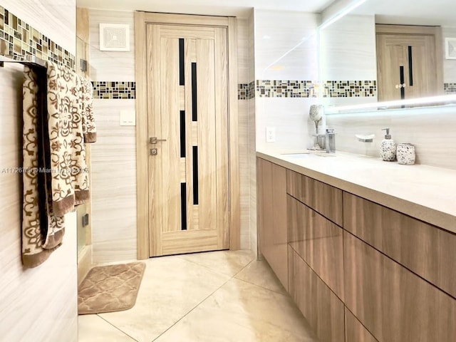 bathroom with tile walls and vanity